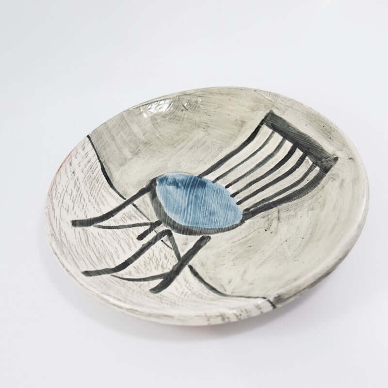 Dinner Plate with Black and Blue Chair at PINCH
