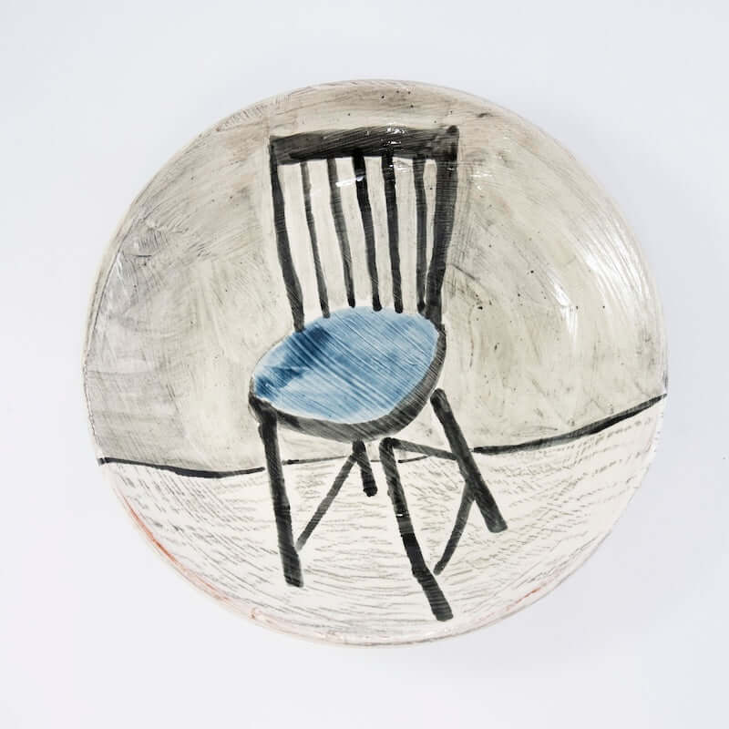 Dinner Plate with Black and Blue Chair at PINCH