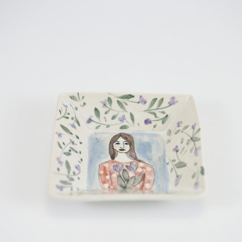 Square Dish with Woman Holding Purple Flowers from Megan Hart at Pinch in Northampton, MA