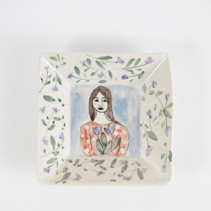 Square Dish with Woman Holding Purple Flowers from Megan Hart at Pinch in Northampton, MA
