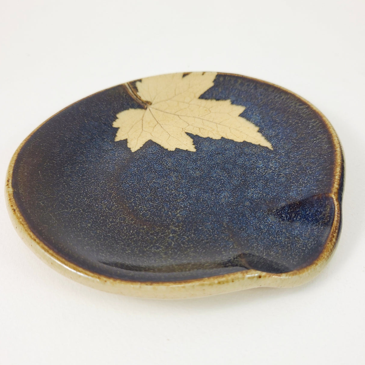 Maple Leaf Spoonrest in Dark Blue Glaze from Kaleidoscope Pottery at Pinch in Northampton, MA