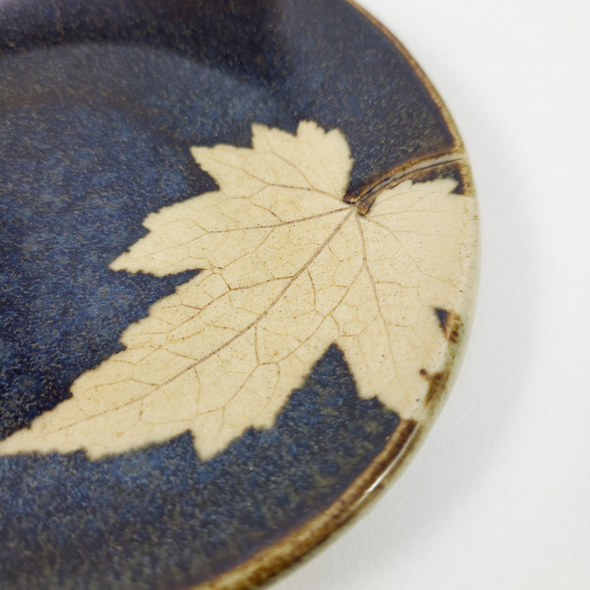 Maple Leaf Spoonrest in Dark Blue Glaze from Kaleidoscope Pottery at Pinch in Northampton, MA