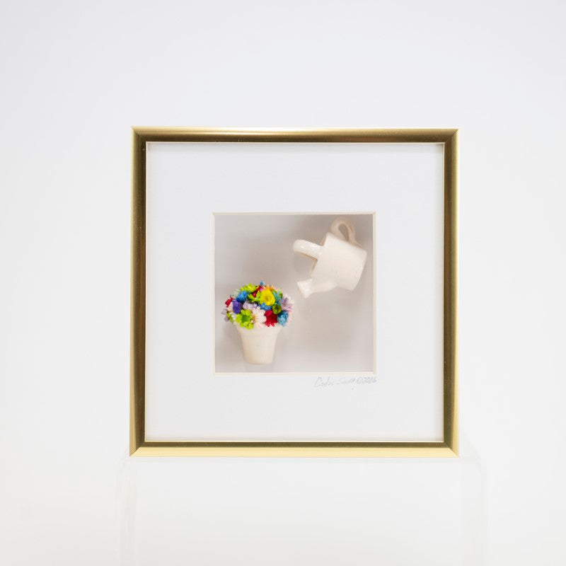6x6 Shadowbox with a White Watering Can, Pot and Colorful Flowers in a Gold Frame