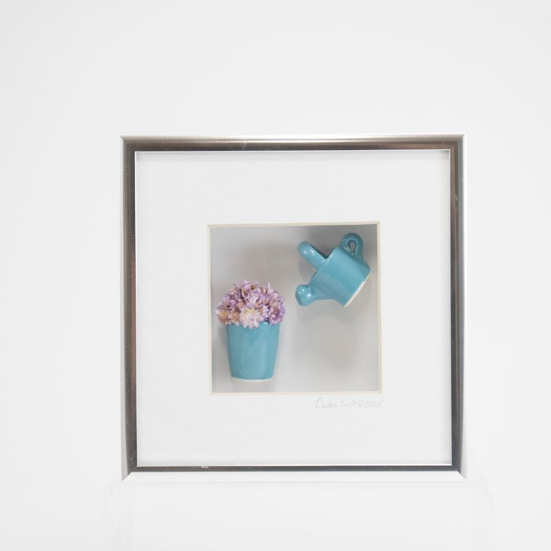 6x6 Shadowbox with a Blue Watering Can, Pot, and Purple Flowers in a Silver Frame