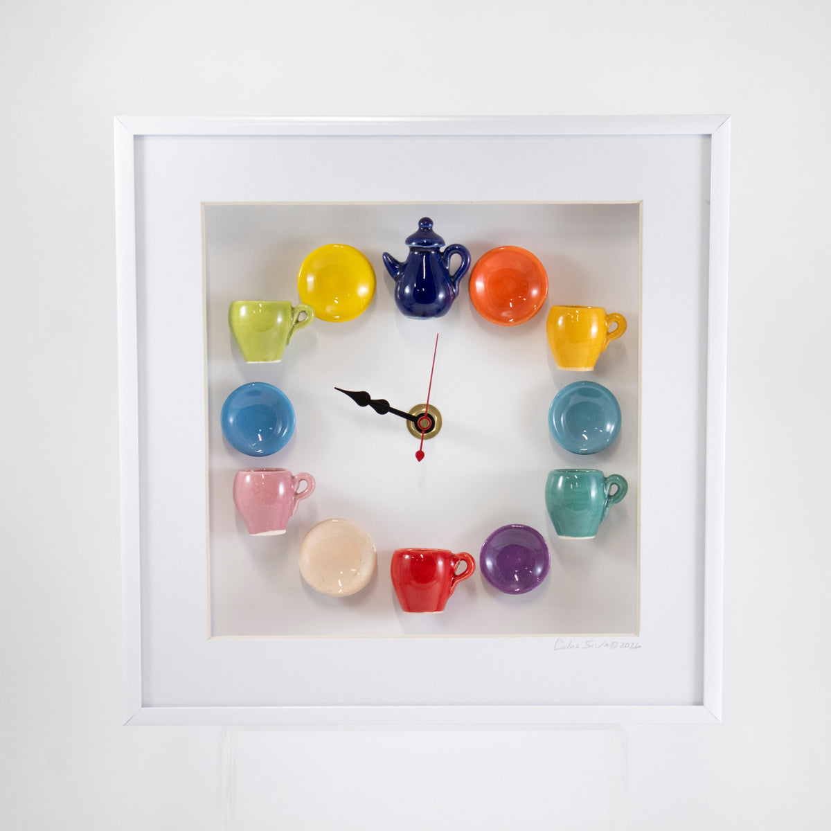10x10 Clock with a Blue Teapot and an Orange Plate in a White Frame