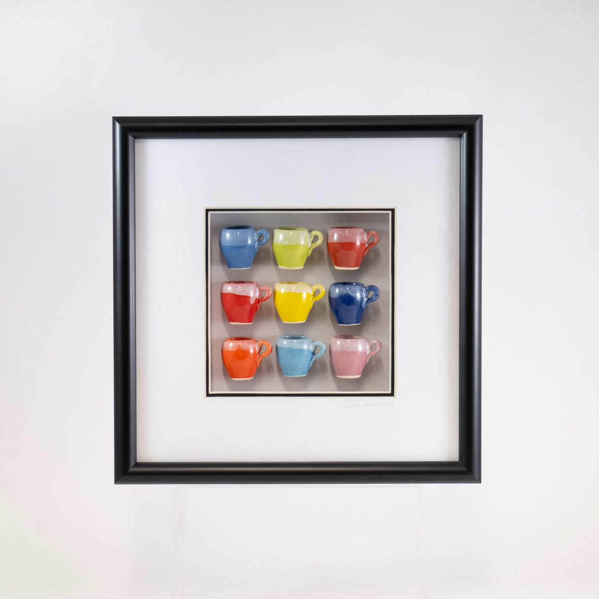 10x10 Shadow Box with a Yellow Mug in a Black Frame