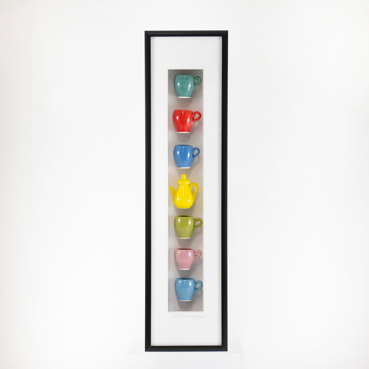 4x16 Vertical Shadowbox with a Light Blue Mug and Yellow Teapot in a Black Frame