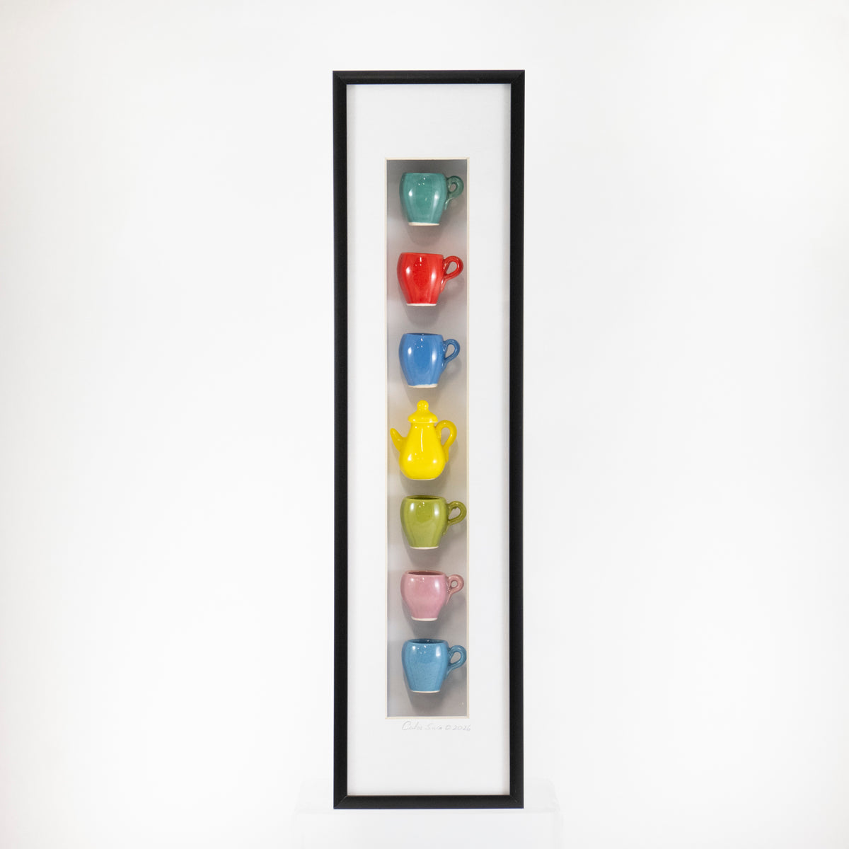 4x16 Vertical Shadowbox with a Light Blue Mug and Yellow Teapot in a Black Frame