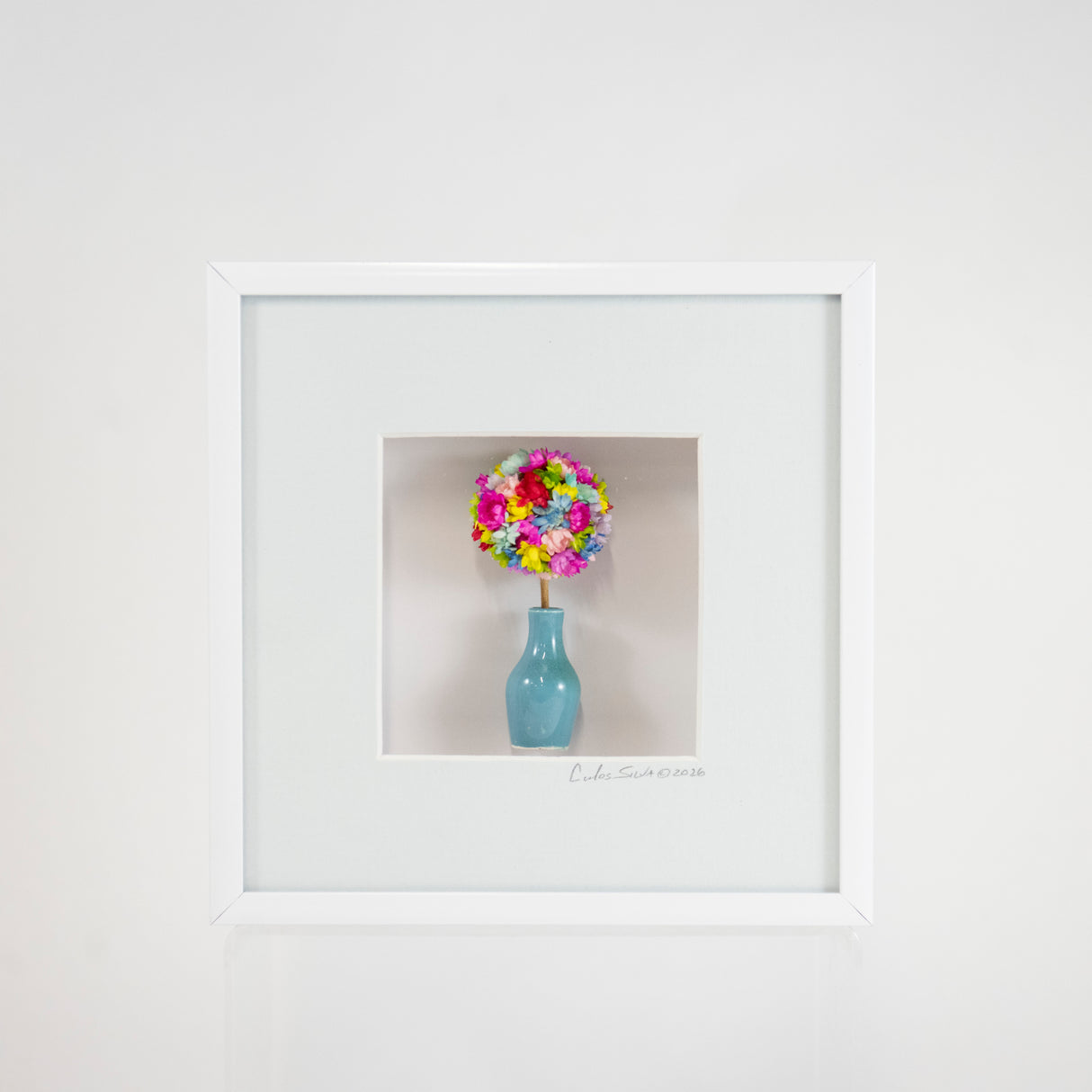 6x6 Shadowbox with a Teal Vase and Colorful Flowers in a Pale Blue Matte and White Frame