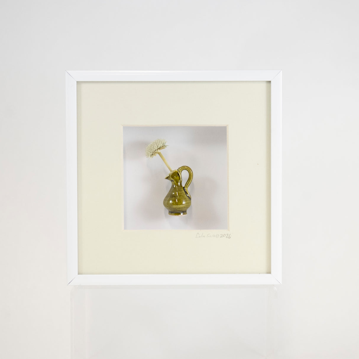 6x6 Shadowbox with a Green Vase and Flower in a Pale Green Matte and White Frame